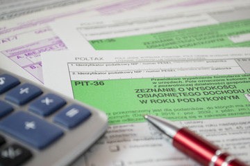 Close up of Polish income tax forms on desk. Accountant performs tax settlements