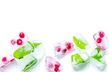 frozen red berries in ice cubes on white background space for te