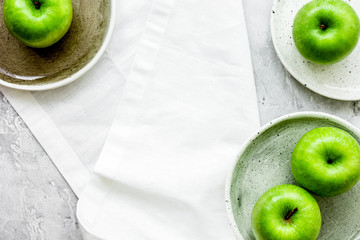 Healthy green food with apples on plates stone background top vi