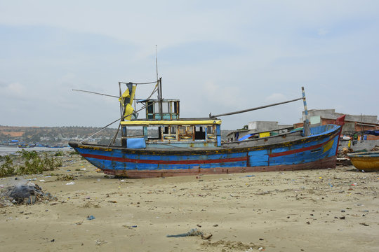 An old abandoned fishing boat in Mui Ne Fishing Village, Binh Thuan Province, Vietnam
