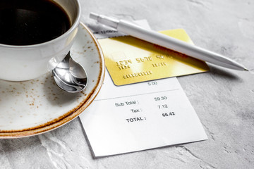 restaurant bill paying by credit card for coffee on stone table 