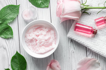 organic cosmetic with rose oil on wooden background top view