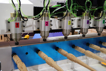 Multi-spindle milling machine manufactures decorative feet for furniture.