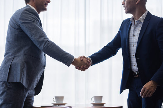 Business men shaking hands with each other after a deal