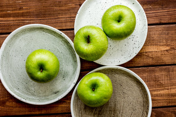 summer food with green apples on wooden background top view