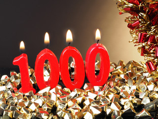 Birthday-anniversary candle showing Nr. 1000
Lit red candle good for an anniversary or birthday...