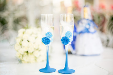 The glasses of the newlyweds. Champagne and a bouquet of the bride. Wedding day. Wedding decorations