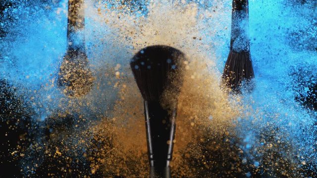 Make up brush and colored powder/particles exploding. Shot with high speed camera, phantom flex 4K. Slow Motion.