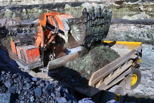 Large quarry dump truck. Loading the rock in the dumper. Loading coal into body work truck.