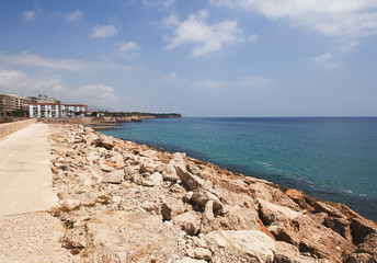 Rocks and sea on the coast under a blue sky. Landscape.