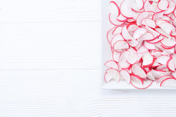 Natural background with fresh radishes slices