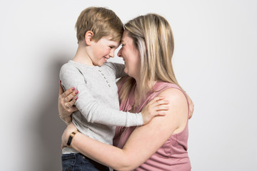 Mother and son on studio white background