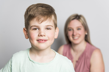 Mother and son on studio white background