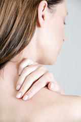 Obraz na płótnie Canvas Studio shot of young woman with neck pain