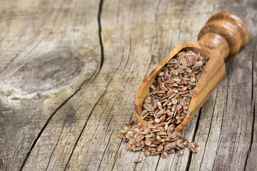Flaxseed organic seeds. Wood background - Linum usitatissimum
