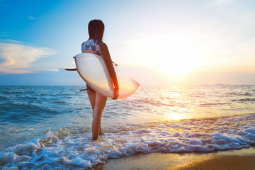 Rear view of beautiful sexy young woman surfer girl
