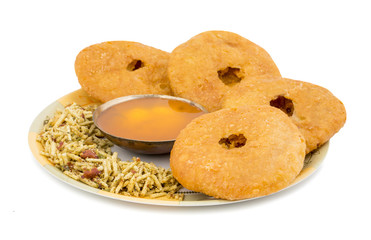Indian Traditional Sweet Kachori Also Know As Mawa Kachori, Kachauri or Kachodi, Stuffed Kachori With Condensed Milk, Cheese and Dry Fruits And Served With Sugar Syrup isolated on White Background