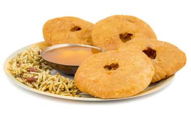 Indian Traditional Sweet Kachori Also Know As Mawa Kachori, Kachauri or Kachodi, Stuffed Kachori With Condensed Milk, Cheese and Dry Fruits And Served With Sugar Syrup isolated on White Background