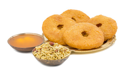 Indian Traditional Sweet Kachori Also Know As Mawa Kachori, Kachauri or Kachodi, Stuffed Kachori With Condensed Milk, Cheese and Dry Fruits And Served With Sugar Syrup isolated on White Background