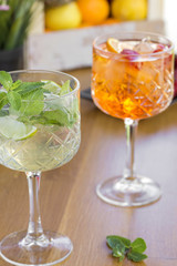 Two cocktails with vodka, strawberries, mint and lemon in glasses