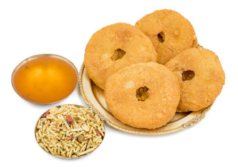 Indian Traditional Sweet Kachori Also Know As Mawa Kachori, Kachauri or Kachodi, Stuffed Kachori With Condensed Milk, Cheese and Dry Fruits And Served With Sugar Syrup isolated on White Background