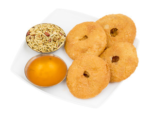 Indian Traditional Sweet Kachori Also Know As Mawa Kachori, Kachauri or Kachodi, Stuffed Kachori With Condensed Milk, Cheese and Dry Fruits And Served With Sugar Syrup isolated on White Background