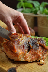 Sliced freshly baked pork on wooden background