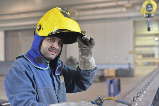 Portrait of smiling welder in factory