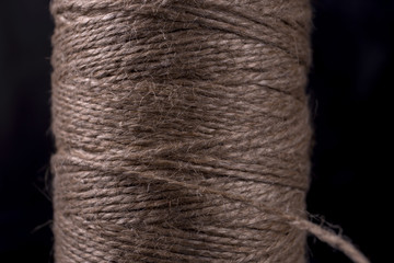Natural thread in the coil on a black background