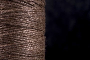 Natural thread in the coil on a black background
