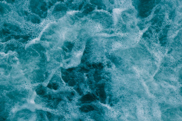 Bright abstract light turquoise background, water with white foam and bubbles