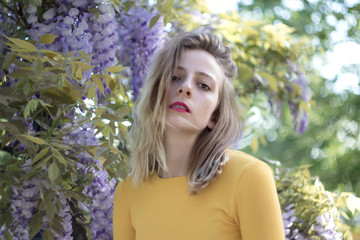 Portrait of a young woman on a wisteria background