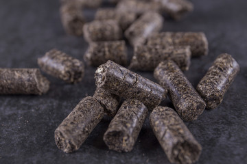 Pellets - new environmentally friendly fuel, close-up on a black background