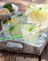 refreshing lemonade drink with mint lime lemon in garden