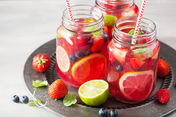 summer berry lemonade with lime and mint in mason jar