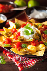 nachos loaded with salsa, cheese and jalapeno