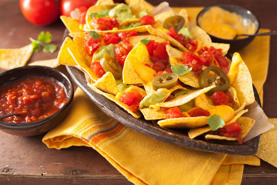 nachos loaded with salsa, guacamole, cheese and jalapeno