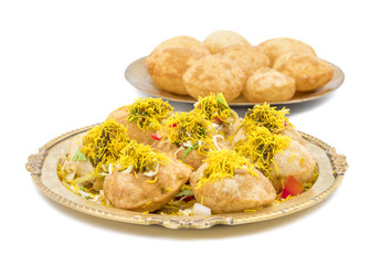 Indian Spicy Chaat Item Sev Puri Stuffed With Potato, Sev Namkeen, Coriander, Chutney isolated on White Background. It is a Most Popular Snack of Mumbai, Maharashtra