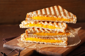grilled cheese sandwich on rustic brown background © Olga Miltsova