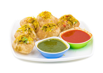 Indian Spicy Chaat Item Sev Puri Stuffed With Potato, Sev Namkeen, Coriander, Chutney isolated on White Background. It is a Most Popular Snack of Mumbai, Maharashtra