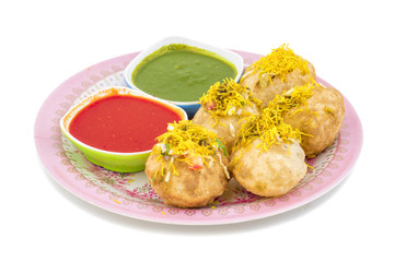 Indian Spicy Chaat Item Sev Puri Stuffed With Potato, Sev Namkeen, Coriander, Chutney isolated on White Background. It is a Most Popular Snack of Mumbai, Maharashtra