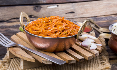 Spicy Fried Vegetable Veg Chow Mein Served With Green And Red Chutney Also Know as Noodles or Hakka Noodles is a Popular Oriental Dish With Noodles And Vegetables on Wooden Table