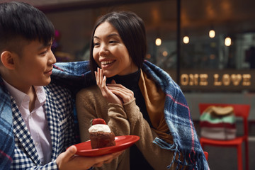 Guy with girl in cafe at table.
