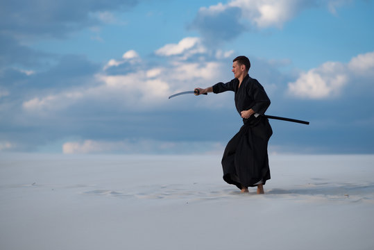 Man is training martial arts in desert