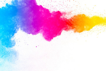 Obraz premium Multi color powder explosion on white background. Launched colorful dust particles splashing.