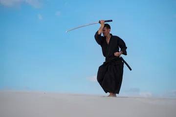Wall murals Man is training Japanese martial arts in desert