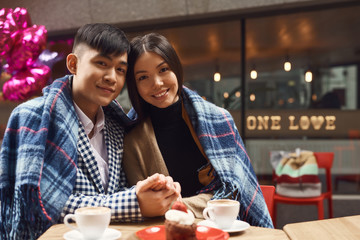 Guy with girl in cafe at table.