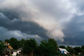 Extreme thunderstorm shelf cloud. Summer landscape of severe weather