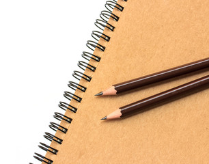 kraft paper note book and pencil on white background.