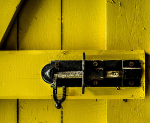 The clench of a wooden door.